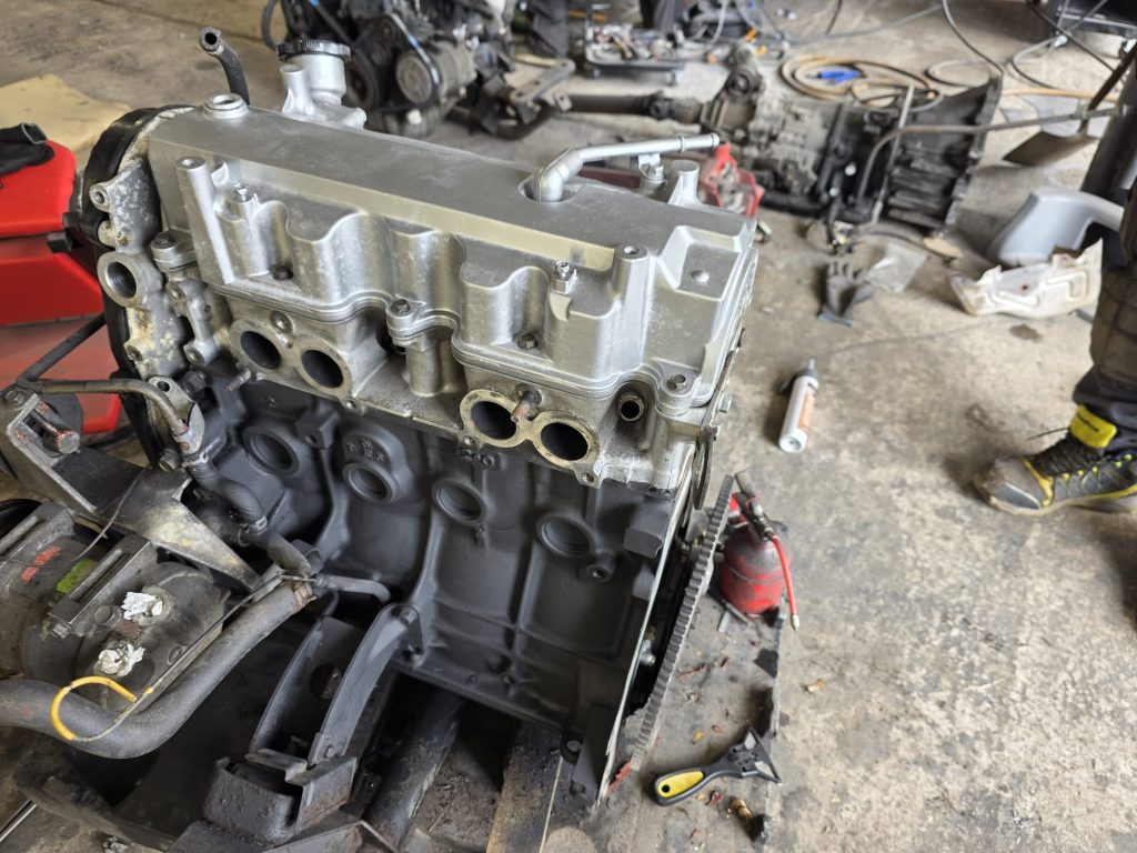 Refurbished cylinder head being fitted to replacement Bongo engine