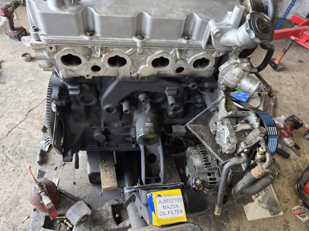 Refurbished cylinder head being fitted to replacement Bongo engine