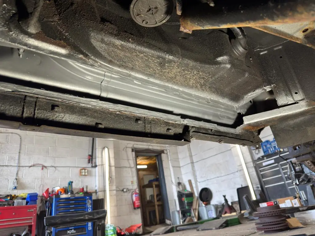 New metal sections being welded into inner sill and crossmember