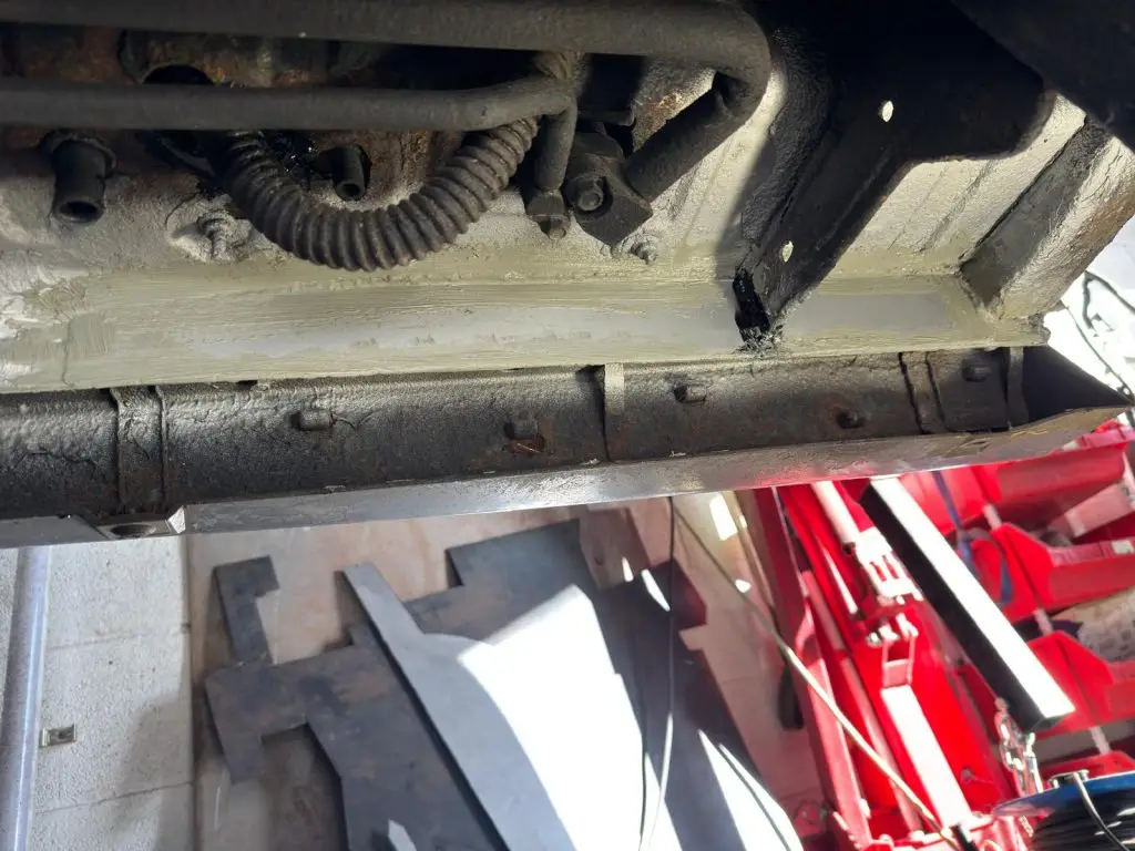 New metal sections being welded into inner sill and crossmember
