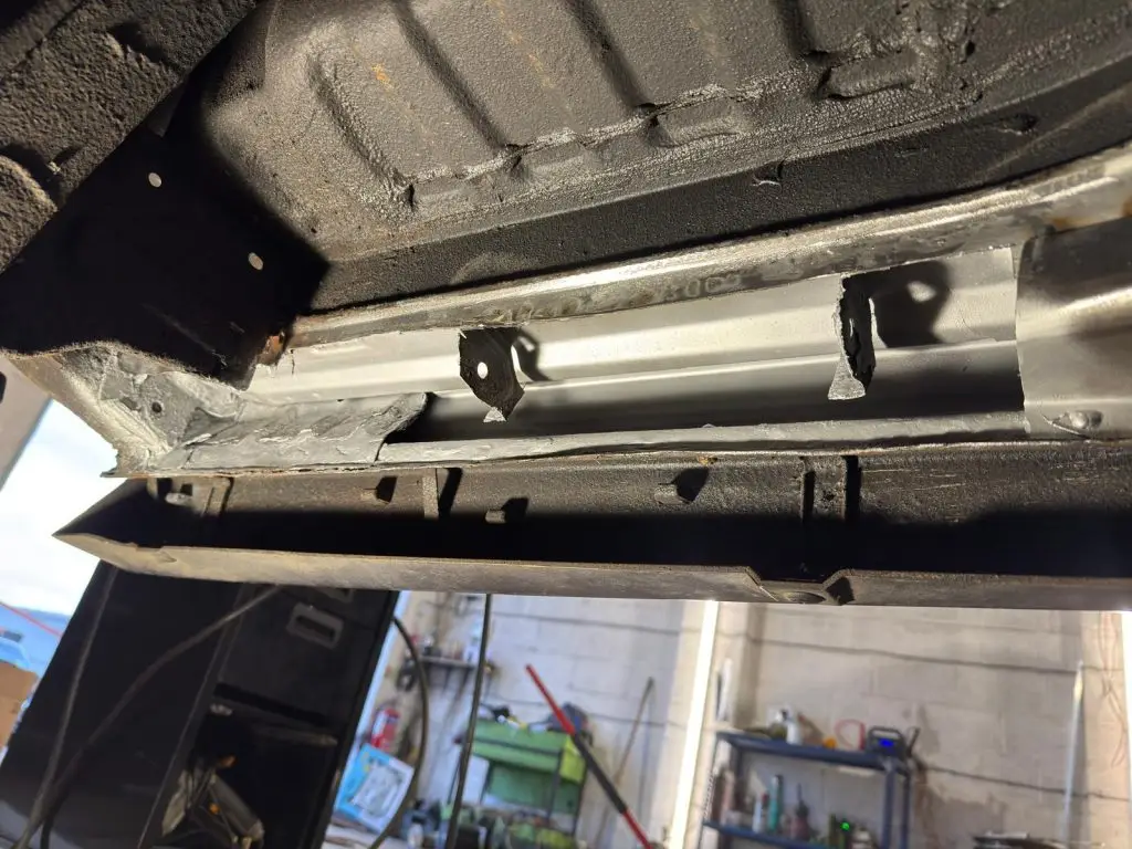 New metal sections being welded into inner sill and crossmember