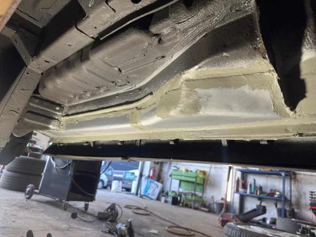 New metal sections being welded into inner sill and crossmember