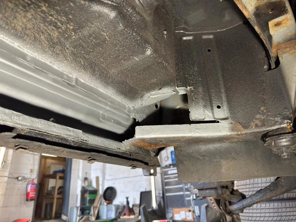 New metal sections being welded into inner sill and crossmember
