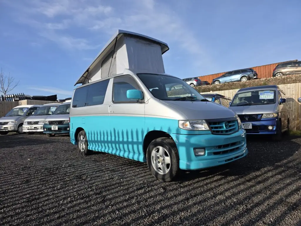 Side view of Mazda Bongo campervan showing pop top roof