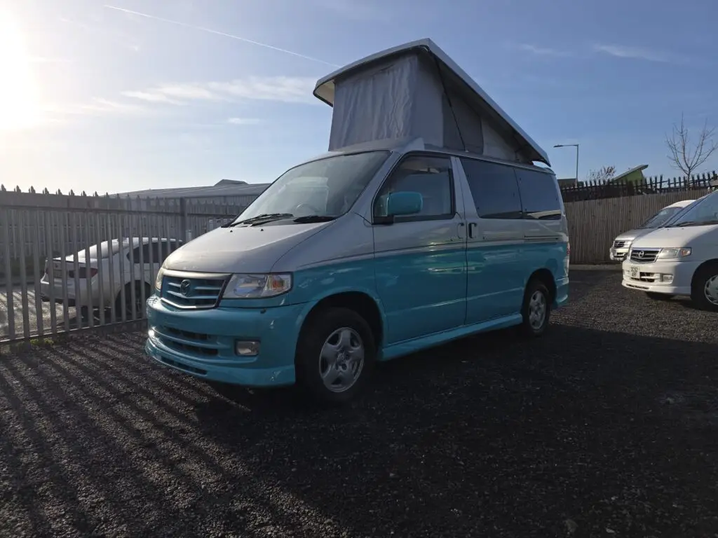 Side view of Mazda Bongo campervan showing pop top roof